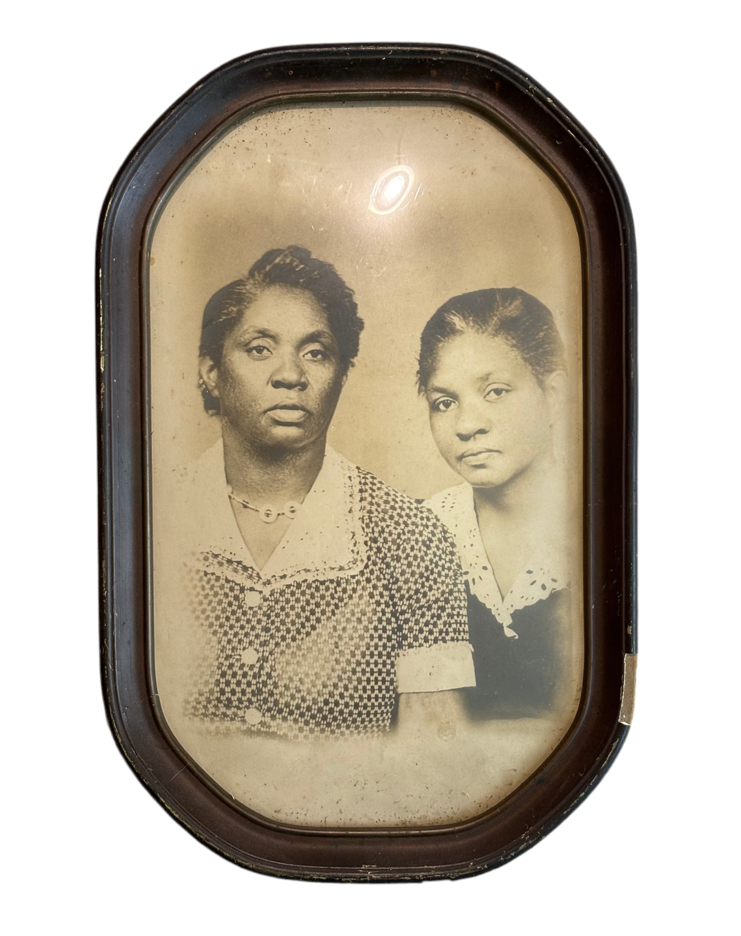 Vintage photograph of two women in a wooden frame